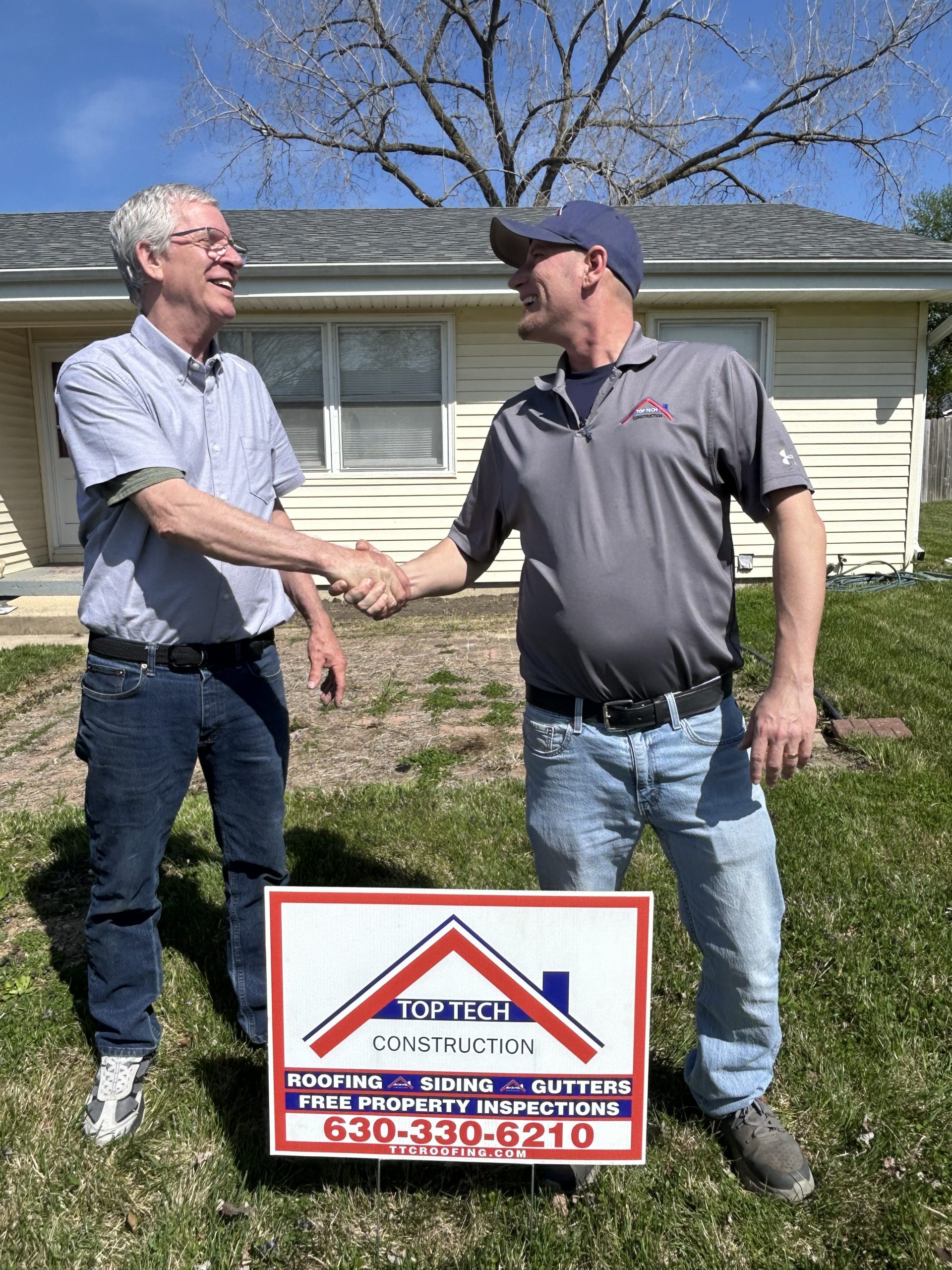 Web Pic 1 shaking hands over sign